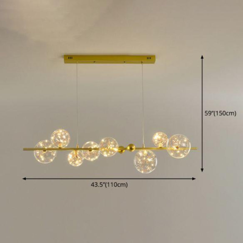 Gold pendant light fixture with spherical bulbs on a gray background, showing measurements.