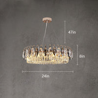 Thumbnail for A modern gold crystal chandelier hanging in a living room setting, with a round glass table and beige sofa below.