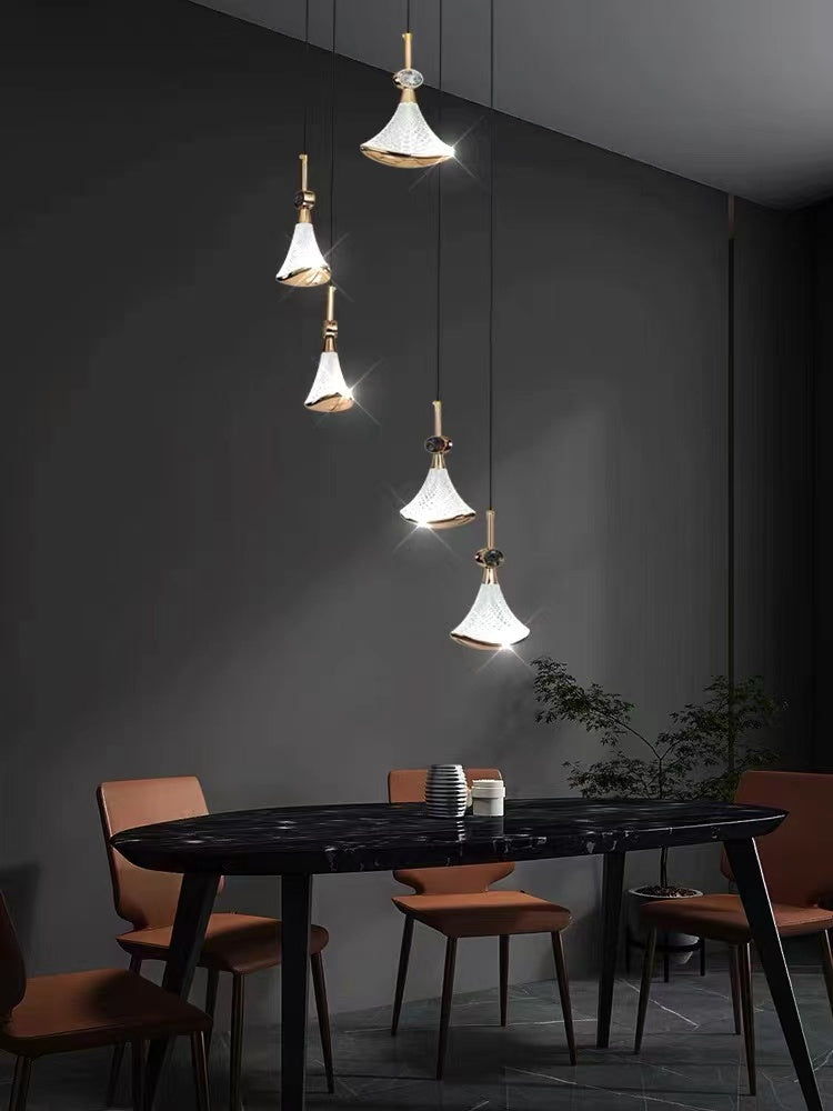 Stainless steel chandelier light with Shell Cascade design creating modern lighting for staircase foyer entryway two-story space