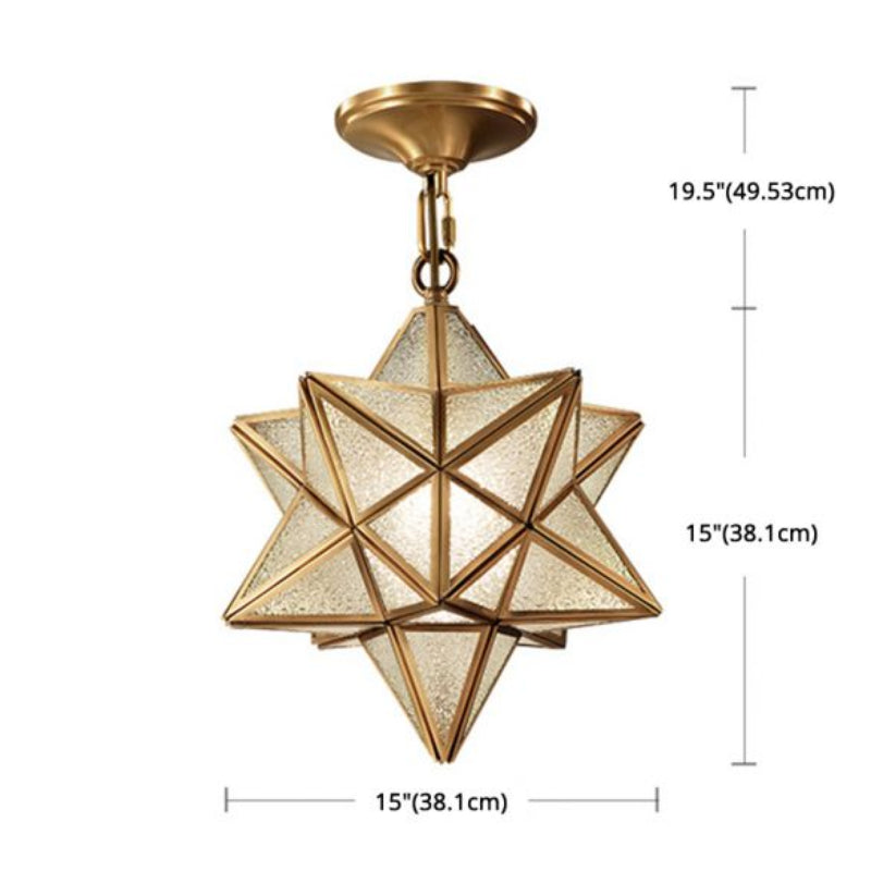 Clear glass star pendant with brass metal and down lighting creating bright focused illumination for kitchen entryway dining room