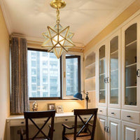 Thumbnail for Brass star pendant with down lighting and adjustable chain creating functional illumination for kitchen dining room entryway