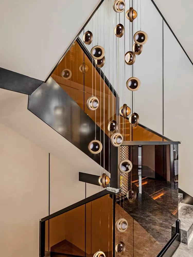 Crystal chandeliers with Star Light Bubbles design creating elegant lighting for modern staircase foyer two-story space