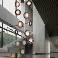 Thumbnail for Modern crystal chandelier with a spiral design, featuring clear glass bubbles and gold-colored metal parts, installed in a staircase setting.