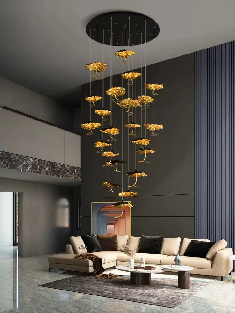 A modern gold chandelier with a unique lotus art design, featuring multiple tiered circles, suspended from a circular canopy, installed in a luxurious living room setting.